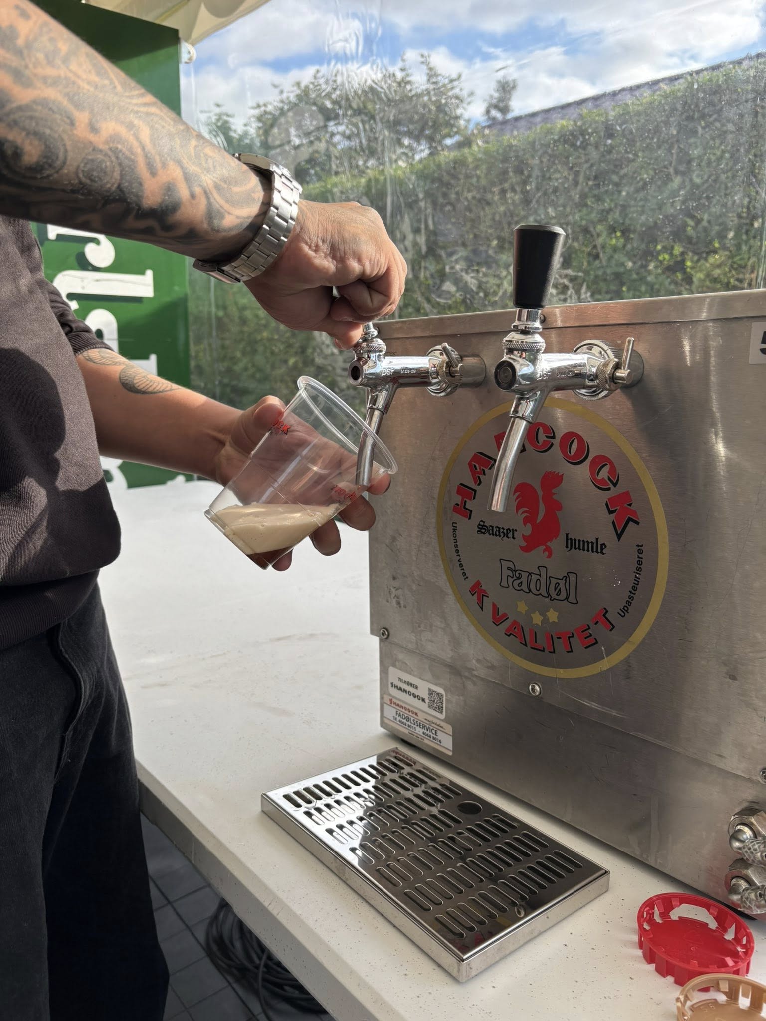 Eight shirts arranged on table in black, olive, grey, blue, white, red, mustard, and green.
