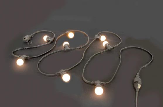 Eight shirts arranged on table in black, olive, grey, blue, white, red, mustard, and green.