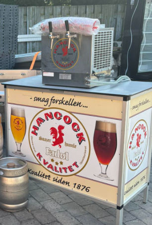 Eight shirts arranged on table in black, olive, grey, blue, white, red, mustard, and green.