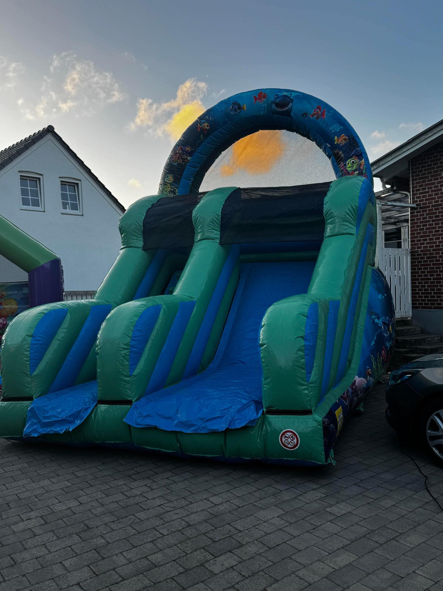 Eight shirts arranged on table in black, olive, grey, blue, white, red, mustard, and green.