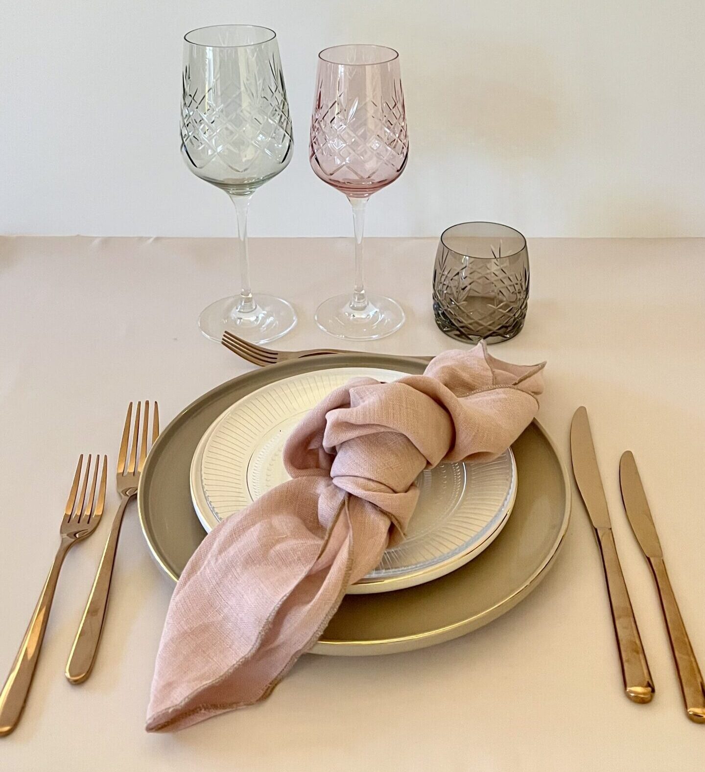 Eight shirts arranged on table in black, olive, grey, blue, white, red, mustard, and green.