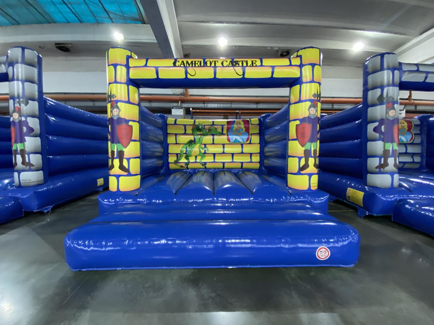 Eight shirts arranged on table in black, olive, grey, blue, white, red, mustard, and green.