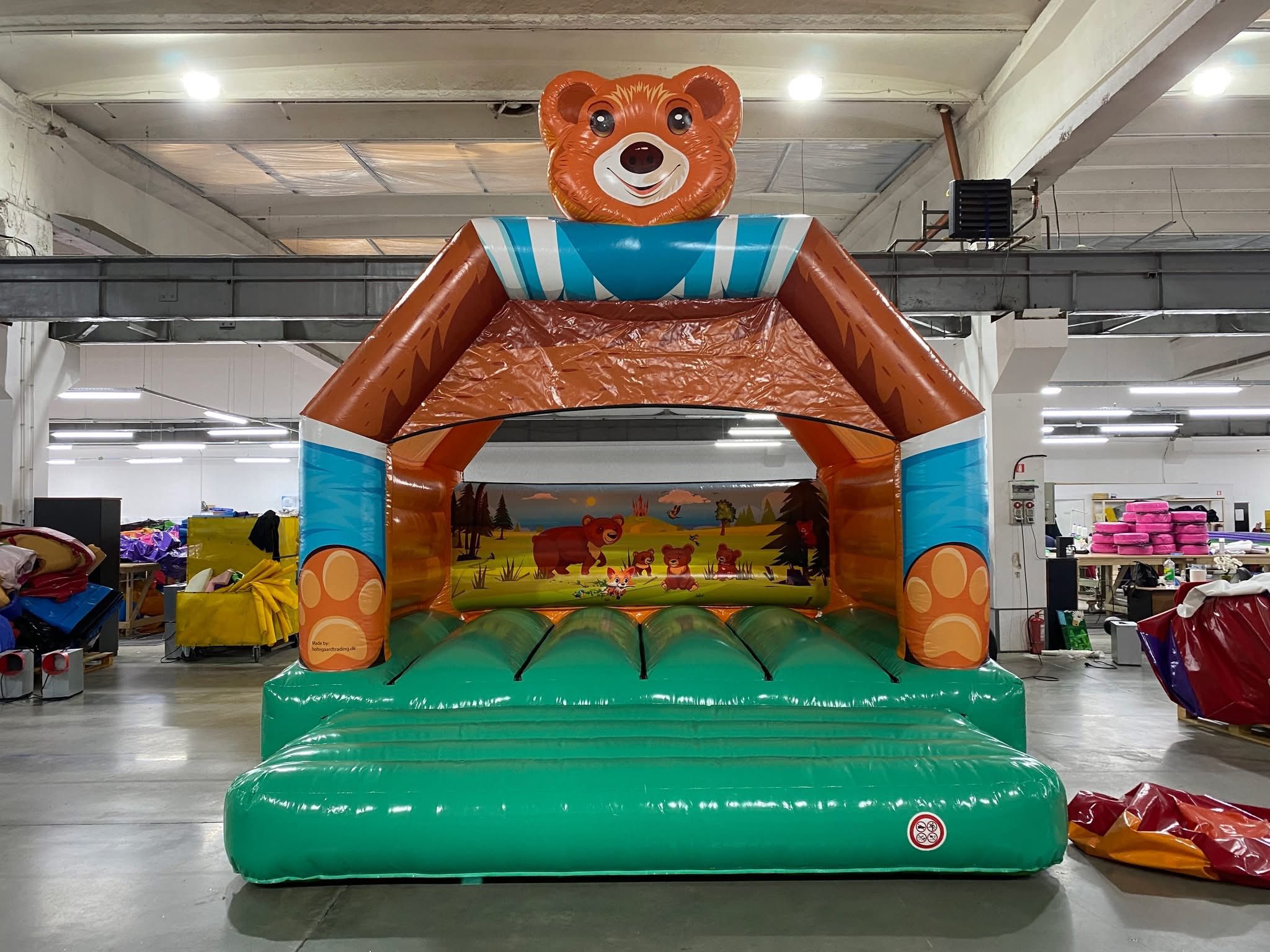 Eight shirts arranged on table in black, olive, grey, blue, white, red, mustard, and green.