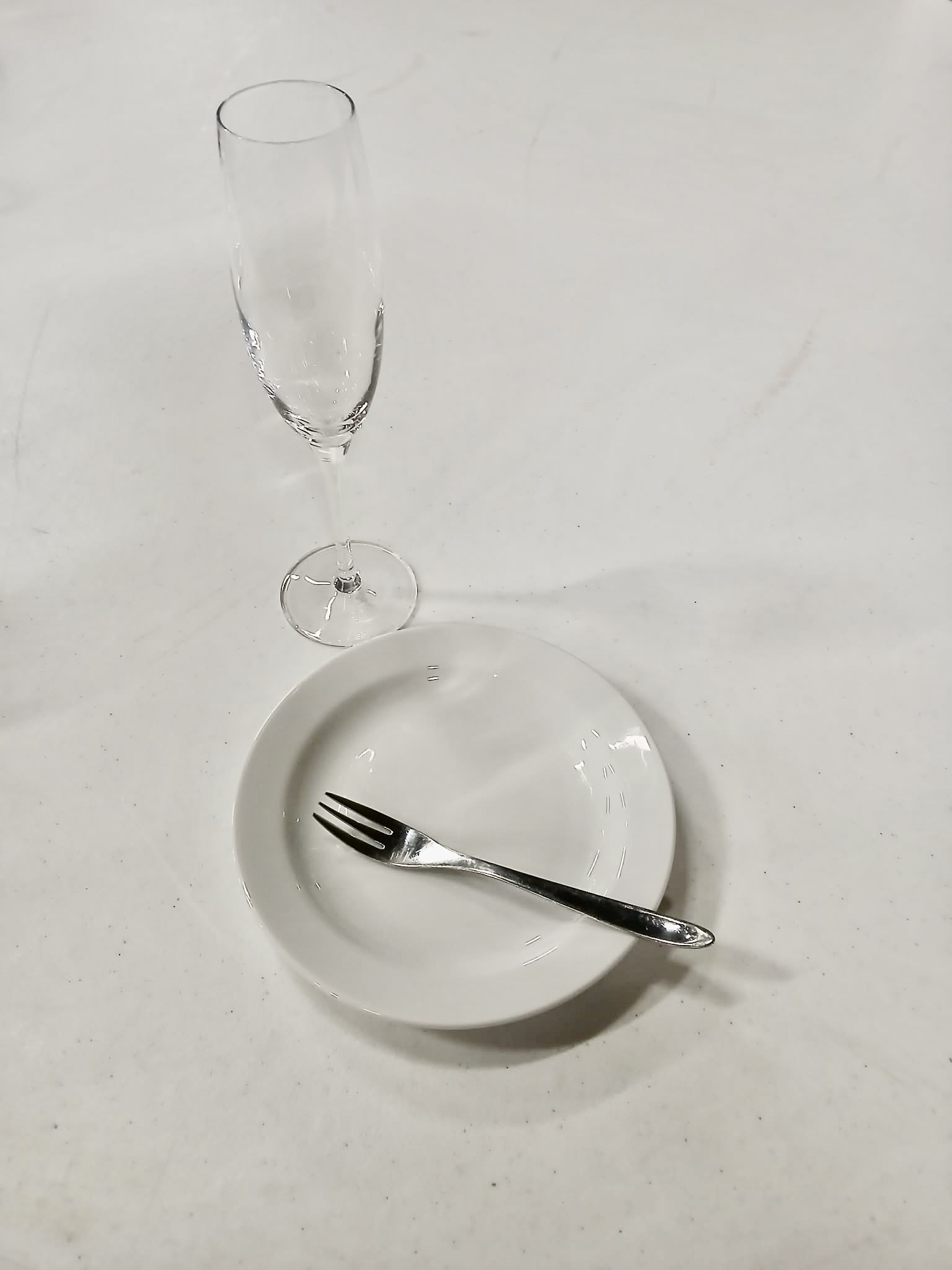 Eight shirts arranged on table in black, olive, grey, blue, white, red, mustard, and green.