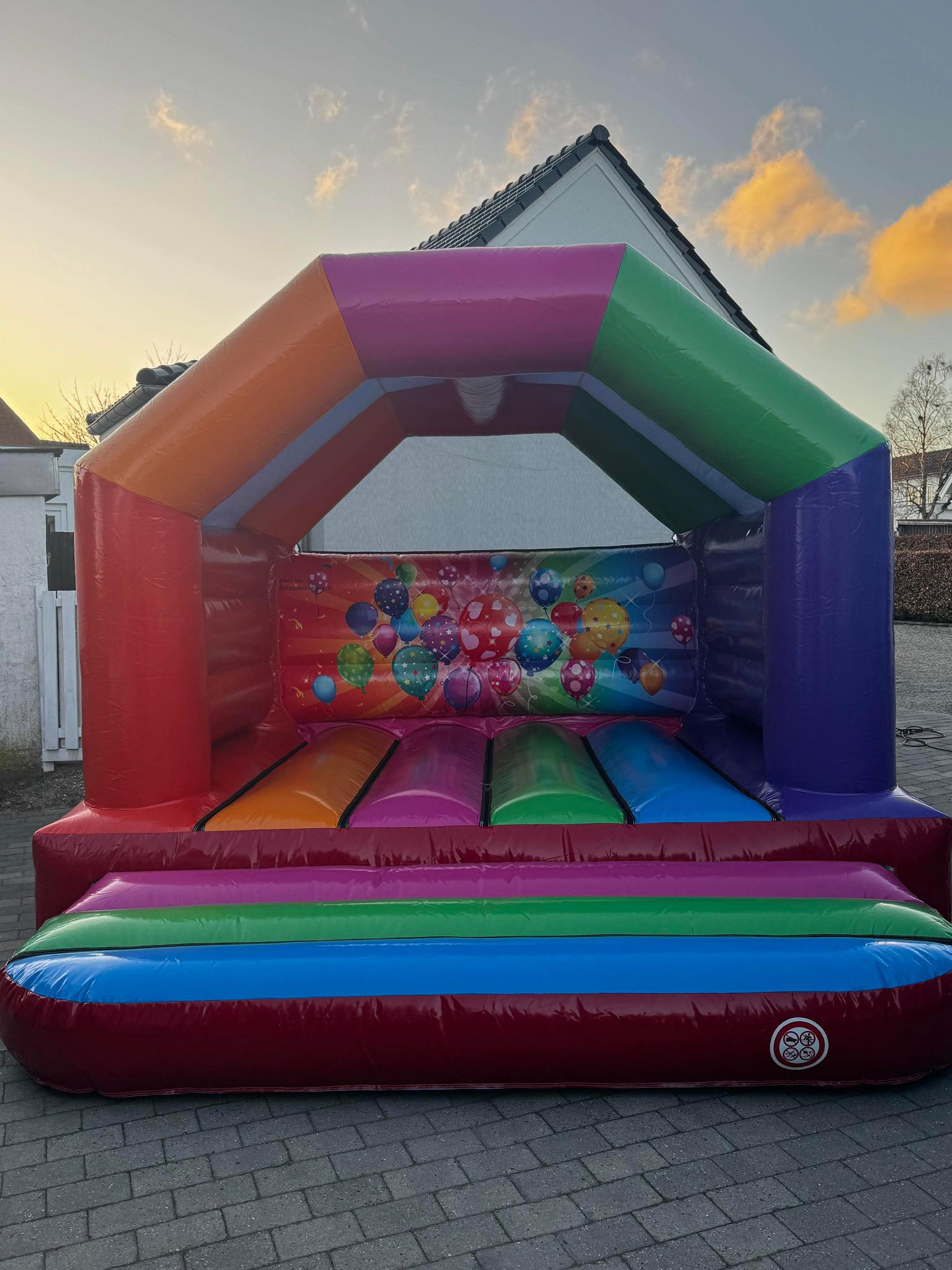 Eight shirts arranged on table in black, olive, grey, blue, white, red, mustard, and green.
