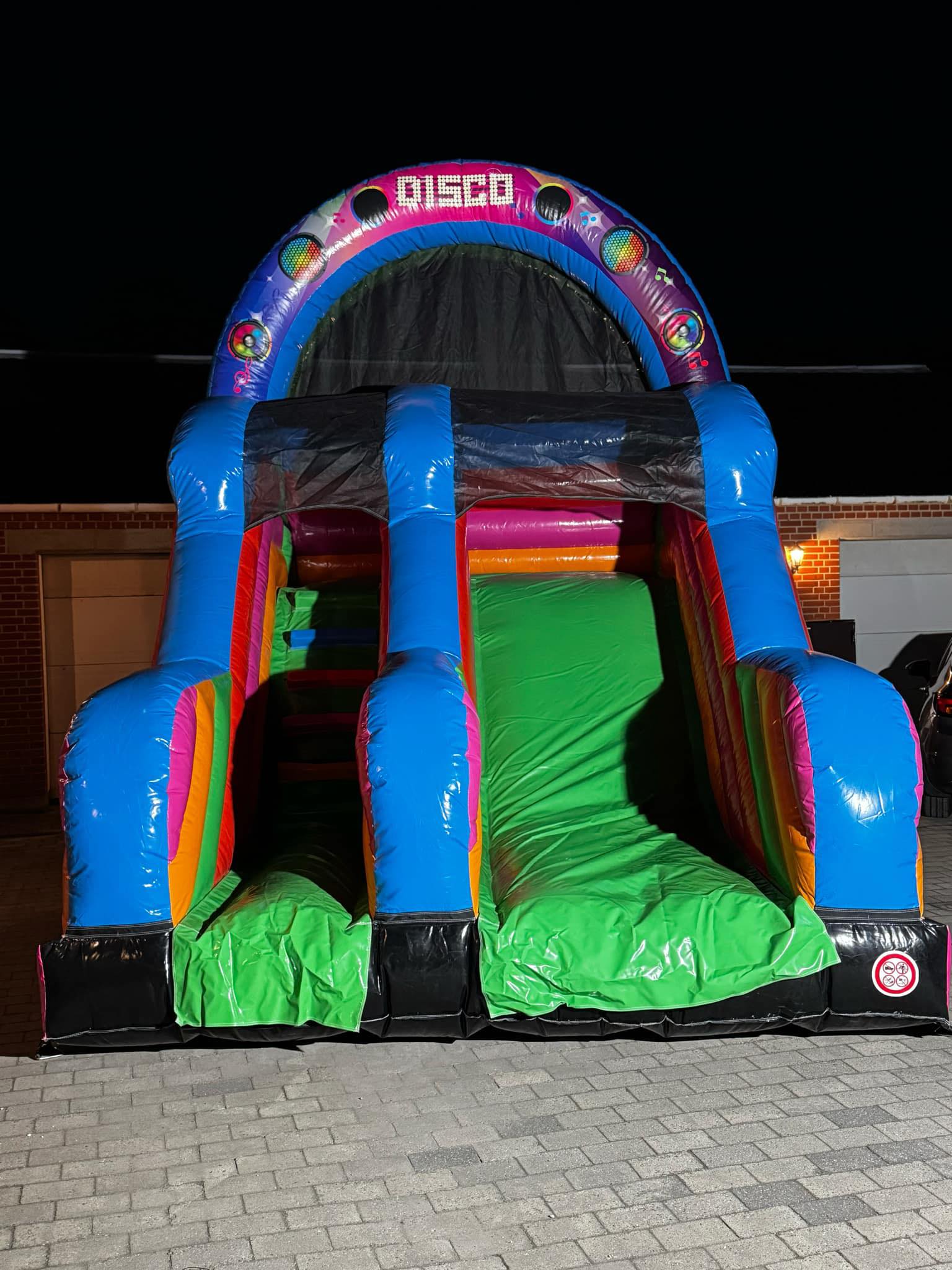 Eight shirts arranged on table in black, olive, grey, blue, white, red, mustard, and green.